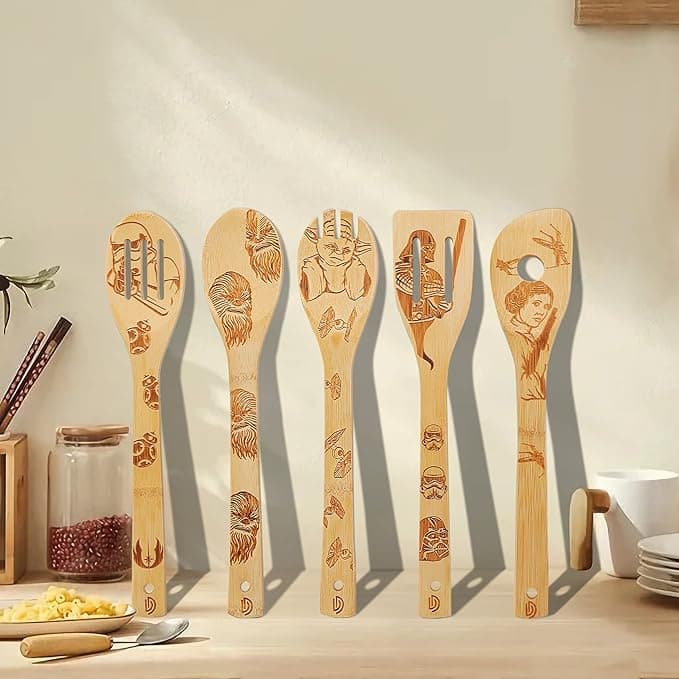 Set of 5 wooden kitchen utensils engraved with Star Wars characters, laid out on a counter like the ultimate nerdy cooking arsenal.