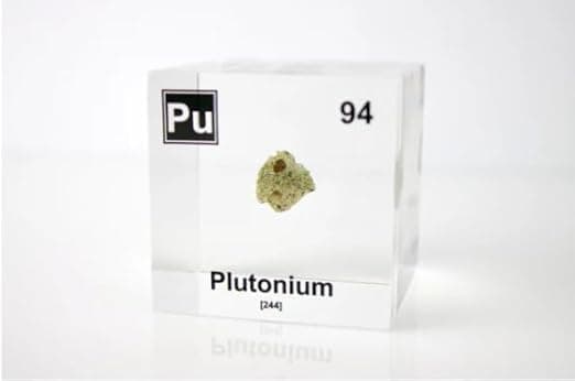 Clear acrylic cube with green trinitite sample from first atomic test—radioactive vibes, minus the danger