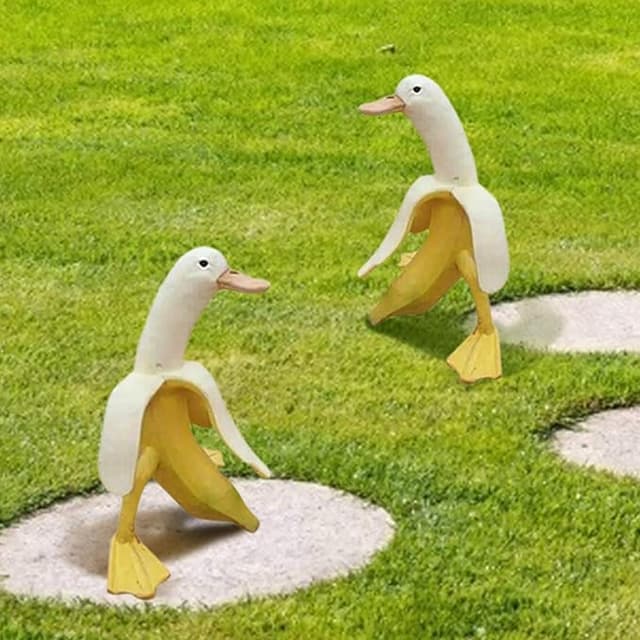 Banana duck sculpture with a duck head and banana body—quirky outdoor decor for gardens, yards, or surreal art lovers.
