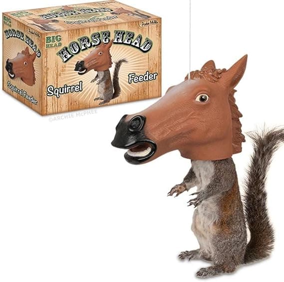 A hanging horse head-shaped squirrel feeder designed so squirrels appear to wear the mask while eating.