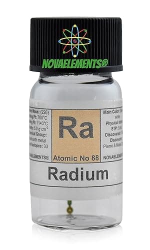 A small glass vial labeled "Radium Element 88" containing a vintage watch hand, used for radioactive demonstration or novelty collecting.